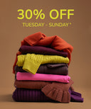 A promotional sale graphic showing a stacked pile of folded knit sweaters in multiple colors, including rust orange, plum, yellow, charcoal, pink, brown, and purple, with large yellow text reading '30% OFF TUESDAY - SUNDAY *' on a warm tan background.
