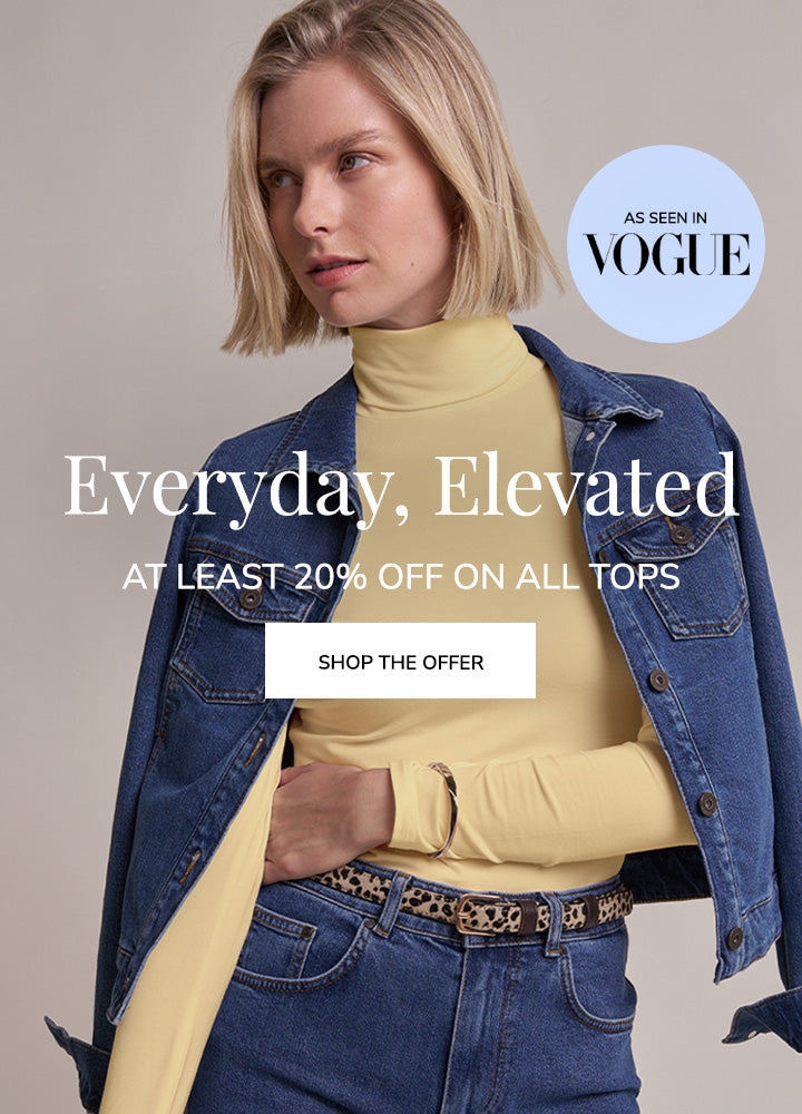 Three-panel fashion advertisement showing a woman modeling a pale yellow mock-neck long-sleeve top with blue denim jackets and blue jeans against a light beige studio background. Large text reads 'Everyday, Elevated' with a 'Shop the Offer' button, and a circular badge says 'As seen in Vogue'.